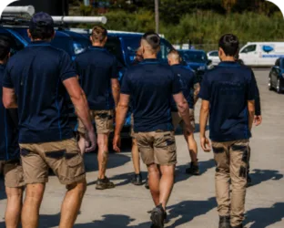 Plumbers walking to their service vans on a Concord job